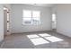 This bedroom features natural light from the window and neutral carpet flooring for comfort at 116 Durham Rd, Stanley, NC 28164