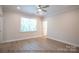 Light-filled bedroom featuring wood floors and access to a bathroom at 116 Durham Rd, Stanley, NC 28164