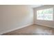 Simple bedroom with wood floors and a window providing natural light at 116 Durham Rd, Stanley, NC 28164