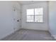 This bedroom features a window for natural light, neutral carpet flooring, and a closet at 116 Durham Rd, Stanley, NC 28164