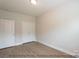 Well-lit bedroom with double doors leading to a closet and wood floors at 116 Durham Rd, Stanley, NC 28164