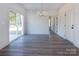 Dining area with wood-look floors, a chandelier, a sliding glass door, and white trim at 116 Durham Rd, Stanley, NC 28164