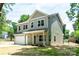 Two-story home with a green door, landscaping, and attached garage at 116 Durham Rd, Stanley, NC 28164