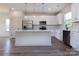 Modern white kitchen with stainless steel appliances, quartz countertops, and stylish pendant lighting at 116 Durham Rd, Stanley, NC 28164