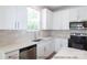 White kitchen with stainless steel appliances and subway tile backsplash at 116 Durham Rd, Stanley, NC 28164