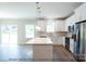 Kitchen island with white cabinets, quartz countertops, and stainless steel appliances at 116 Durham Rd, Stanley, NC 28164