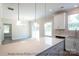 Island kitchen with white cabinets and quartz countertops, open to dining area at 116 Durham Rd, Stanley, NC 28164