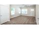 Bright living room with hardwood floors, ceiling fan, and large windows at 116 Durham Rd, Stanley, NC 28164