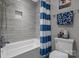 Clean bathroom with a tub, shower, and blue striped curtain at 122 Still Creek Dr, Mooresville, NC 28115