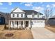 Two-story white house with gray roof, front porch, and attached two-car garage at 122 Still Creek Dr, Mooresville, NC 28115