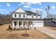 Two-story home with white exterior and covered porch at 122 Still Creek Dr, Mooresville, NC 28115