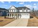 Two-story home with white exterior and covered porch at 122 Still Creek Dr, Mooresville, NC 28115