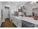 White kitchen island with farmhouse sink and breakfast bar area at 122 Still Creek Dr, Mooresville, NC 28115