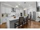 Modern kitchen with white cabinets, stainless steel appliances, and large island at 122 Still Creek Dr, Mooresville, NC 28115