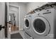 Bright laundry room features washer, dryer, and ample storage at 122 Still Creek Dr, Mooresville, NC 28115