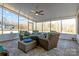 Relaxing screened porch with wicker furniture and tiled floor at 122 Still Creek Dr, Mooresville, NC 28115