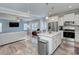 Open-concept kitchen with white cabinets, stainless steel appliances, flowing into the adjacent living area at 1244 Scotch Meadows Loop, Monroe, NC 28110