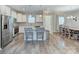 Bright kitchen featuring white cabinets, stainless steel appliances, island with seating and adjacent eating area at 1244 Scotch Meadows Loop, Monroe, NC 28110