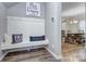 Charming mudroom with coat hooks, bench seating, and decor alongside an adjacent dining area at 1244 Scotch Meadows Loop, Monroe, NC 28110