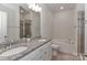 Bathroom with double sink vanity, granite countertops, a bathtub, and modern fixtures at 12849 Robert Walker Dr, Davidson, NC 28036