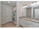 Bathroom featuring double sinks with granite countertops and vanity; the space has neutral tones and flooring at 12849 Robert Walker Dr, Davidson, NC 28036