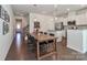 Bright and airy dining area with a large table, open to the kitchen and living spaces at 12849 Robert Walker Dr, Davidson, NC 28036