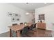 Stylish dining area with wood table, modern chairs, and decorative wall art at 12849 Robert Walker Dr, Davidson, NC 28036