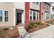 Inviting entryway of townhome with decorative glass door, brick trim, and lush landscaping at 12849 Robert Walker Dr, Davidson, NC 28036