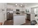 Open kitchen featuring an island, stainless appliances, granite counters, and modern white cabinets at 12849 Robert Walker Dr, Davidson, NC 28036