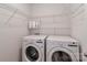 Laundry room features modern appliances, wire shelving, and ample storage for laundry essentials at 12849 Robert Walker Dr, Davidson, NC 28036