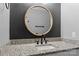 Bathroom features a round mirror, granite countertop and updated faucet at 133 Fieldstone Farm Dr, Statesville, NC 28625