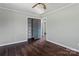 Bedroom with dark wood floors, ceiling fan and spacious closet at 133 Fieldstone Farm Dr, Statesville, NC 28625