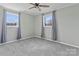 Bedroom with grey carpet, ceiling fan and large windows at 133 Fieldstone Farm Dr, Statesville, NC 28625