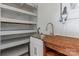 Laundry room with utility sink and shelving at 133 Fieldstone Farm Dr, Statesville, NC 28625