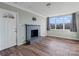 Living room with brick fireplace, wood floors, and large windows at 133 Fieldstone Farm Dr, Statesville, NC 28625