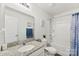 Bright bathroom featuring granite countertop, framed mirror, and bathtub with shower at 1355 Amberlight Cir, Salisbury, NC 28144