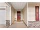 Inviting covered entrance with a neutral-colored exterior and a welcoming red front door at 1355 Amberlight Cir, Salisbury, NC 28144