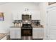 Bright kitchen with white cabinetry, stainless appliances, and stylish backsplash at 1355 Amberlight Cir, Salisbury, NC 28144