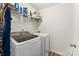 Well-equipped laundry room with a modern washer and dryer and storage shelves at 1355 Amberlight Cir, Salisbury, NC 28144