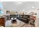 Bright, airy living room featuring hardwood floors, a large sectional sofa, and stylish decor at 1355 Amberlight Cir, Salisbury, NC 28144