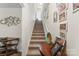 Carpeted stairway with white handrail, decorated with Gathering photos at 1355 Amberlight Cir, Salisbury, NC 28144