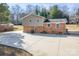 Back exterior of a split-level home with brick and siding, a spacious driveway at 1401 Southwest Blvd, Newton, NC 28658