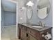 Bathroom featuring double sinks, granite countertops, and oval mirrors at 1401 Southwest Blvd, Newton, NC 28658