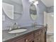 Bathroom featuring double sinks, granite countertops, and oval mirrors at 1401 Southwest Blvd, Newton, NC 28658