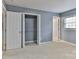 Bedroom featuring an open closet with shelving and a window for natural light at 1401 Southwest Blvd, Newton, NC 28658