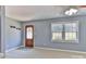 An open living room with great natural light, a wooden front door, and neutral paint throughout at 1401 Southwest Blvd, Newton, NC 28658