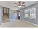 A bright living room with a staircase, a window with blinds, neutral carpet, and wooden accents at 1401 Southwest Blvd, Newton, NC 28658