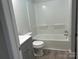 Clean bathroom with tub and shower, gray vanity at 1440 Rhodes Rhyne Rd, Lincolnton, NC 28092