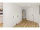 Clean, bright basement area featuring light wood flooring, a water heater, and a white door at 1712 S Main St, Salisbury, NC 28144