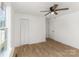 Bedroom features a closet, white walls, ceiling fan, and wood-look floors at 1712 S Main St, Salisbury, NC 28144